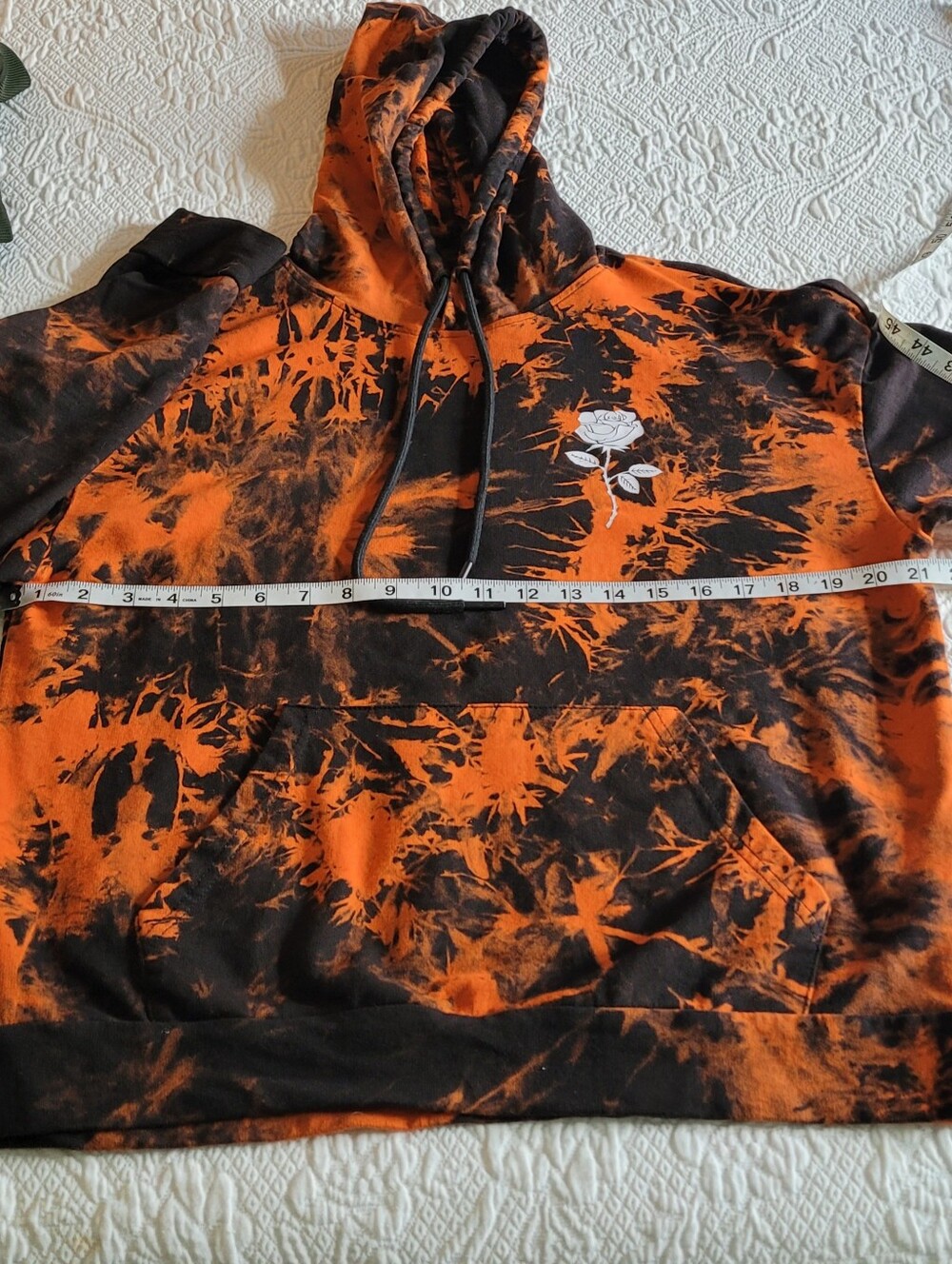 Shein orange and black hooded pullover with rose graphics left front & sleeves